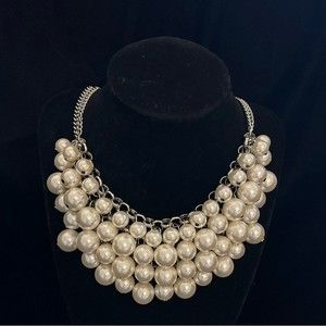 Fashion necklace with 4 layers of pearls and a double silver toned chain.